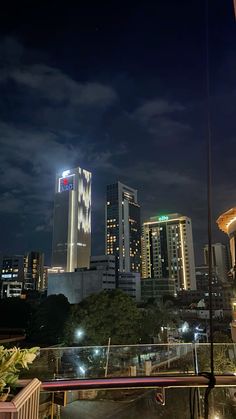 the city skyline is lit up at night