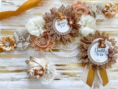 three baby headbands with flowers and ribbons on top of white wood planks