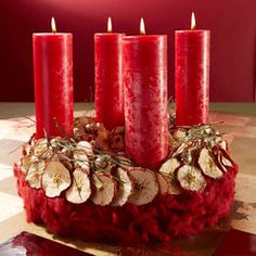 a group of red candles sitting on top of a table