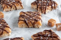 several pieces of food with chocolate drizzled on them