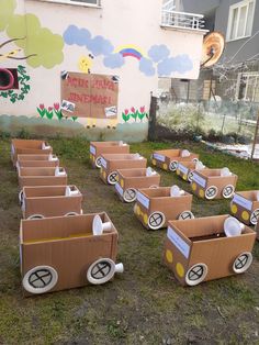 several cardboard train cars sitting in the grass