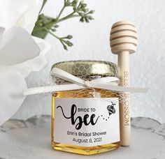 a jar of honey with a wooden stick next to it