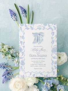 a blue and white wedding card with flowers