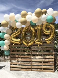 balloons and streamers decorate the entrance to a new year's eve party in an outdoor setting