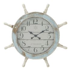 a clock that is on the side of a white ship's wheel with numbers