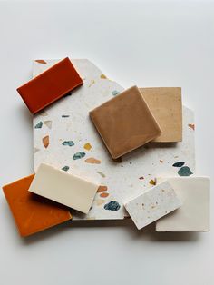 several different types of soap on a white surface