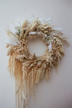 a dried wreath is hanging on the wall