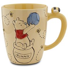 a winnie the pooh coffee mug with honey on it