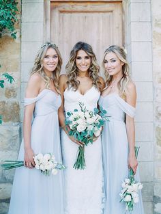 three beautiful women standing next to each other