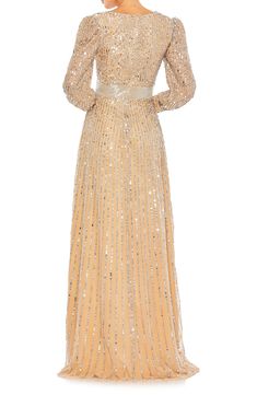 Sequins add sparkly stripes to a classic gown finished with a softly trailing skirt. 60" length Surplice V-neck Long sleeves Lined 100% polyester Spot clean Imported Asian Owned/Founded Elegant V-neck Gown For Reception, Elegant Full-length Gown For Reception, Elegant Full Length Gown For Reception, Elegant Full-length Dress For Reception, Elegant Full-length Reception Dress, Elegant Maxi Dress For Reception, Elegant Full Length Dress For Reception, Fitted Sequin Maxi Dress For Reception, Classic Gown