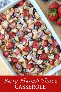 berry french toast casserole with powdered sugar and fresh berries in the background