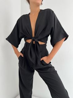 The Bobbie Tie Top is made of luxurious and soft Tencel modal and features a flattering and unique dolman sleeve that drapes beautifully with the body. Intended to be worn with high-waisted trousers, such as the Townes Trousers in Vintage Wash Tencel or the Lena Pants in French Twill . A timeless and unique garment to pair for seasons to come! Made in USA Chic Batwing Sleeve Tops For Loungewear, Chic Tie Waist Top For Night Out, Chic Rayon Blouse For Loungewear, Chic Solid Blouse For Loungewear, Chic Solid Color Blouse For Loungewear, Chic Blouse For Loungewear, Elegant Batwing Sleeve Top For Workwear, Elegant Batwing Sleeve Top For Work, Rayon V-neck Blouse For Loungewear