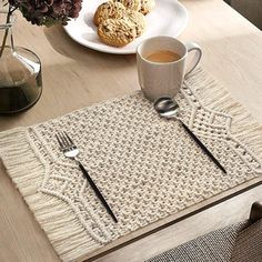 a place mat on a table with coffee and cookies