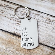 it's too peopley outside dog tag keychain on wooden background with text