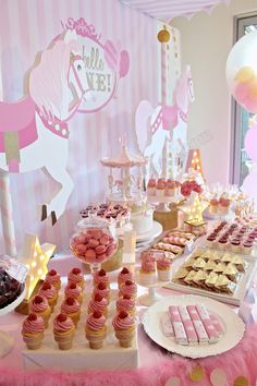 a table filled with lots of desserts and cupcakes on top of plates