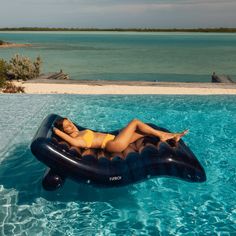 a woman laying on an inflatable floating device