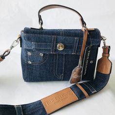 True Religion Dk Blue Jean Pocket Mini Crossbody Guitar Strap Flap Denim Bag * Crossbody / Clutch * Denim * Magnetic Snap Closure. * Adjustable Crossbody Guitar Strap. * Inside Zip Pocket * Silver Tone Hardware * 23" Removable Shoulder Strap * Lined * 9 W X 7" H X 2.5" D Denim Shoulder Bag With Branded Hardware, On-the-go Denim Blue Shoulder Bag, On-the-go Denim Blue Denim Shoulder Bag, Denim Blue Shoulder Bag For On-the-go, Denim Shoulder Bag With Adjustable Strap, Daily Denim Shoulder Bag With Branded Hardware, Daily Use Denim Shoulder Bag With Branded Hardware, Trendy Denim Shoulder Bag With Detachable Strap, Denim Blue Bags With Branded Hardware