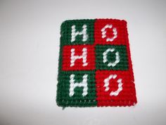 a red and green crocheted square with the letters h o g