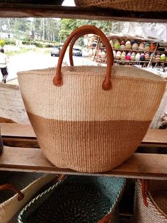 a large basket sitting on top of a wooden shelf