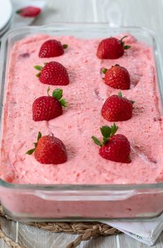 a dessert with strawberries on top in a glass dish