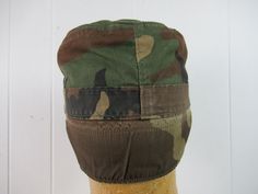 Vintage 1980s green cotton camouflage hat, U.S. Army hat. Has fold down ear and neck flap and stitched brim. Size small. Size 7. In very good condition. Military Camouflage Bucket Hat, Military Style Camouflage Bucket Hat, Military Style Camouflage Flat Cap, Military Camouflage Cap, Military Style Camouflage Cap, Hat With Ear Flaps, Camouflage Hat, Army Hat, Camo Hat