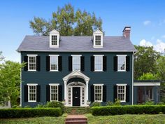 a blue house with black shutters and white trim