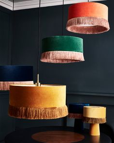 three different colored lamps hanging from the ceiling