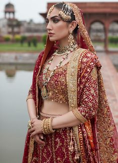 Red Golden Lehenga Choli for Pakistani Bridal Wear is emblazoned in its embroidered work on choli and golden red lehenga paired with net dupatta looking purely traditional in its design and combination of red colored on a chiffon base. Lehenga Kameez: NameerabyFarooq perfectly picked scarlet red to make the bride a sure shot show stopper Heavily embellished in mukesh aari zardozy and threadwork all exclusively embellished by our expert hand artisans. The choli is heavily embellished on the body Gold Anarkali Choli For Traditional Ceremonies, Gold Lehenga With Dupatta For Traditional Ceremonies, Gold Choli With Dupatta For Traditional Ceremonies, Gold Kundan Lehenga For Traditional Ceremonies, Gold Choli With Resham Embroidery For Traditional Ceremonies, Kundan Choli For Traditional Ceremonies At Eid, Kundan Choli With Pallu For Traditional Ceremonies, Traditional Kundan Lehenga With Tilla Details, Red Kundan Lehenga For Eid