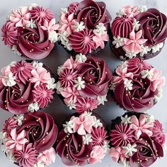 cupcakes decorated with pink and white frosting are arranged in the shape of flowers