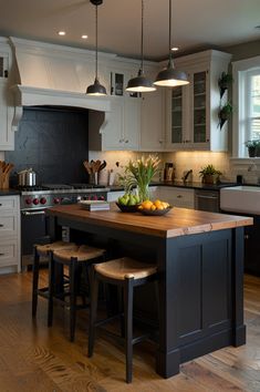 a kitchen with an island and stools in it