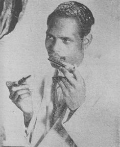 an old black and white photo of a man brushing his teeth