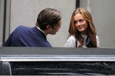 a woman standing next to a man in a suit and tie on the set of gossip