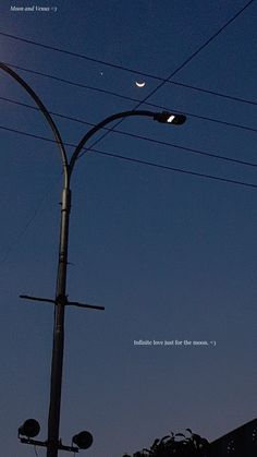 the moon is shining in the sky above power lines