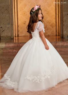 Your sweet girl will captivate the room in this long applique short sleeve dress with A-line skirt by Rachel Allan RB9145. Walk down the aisle in true elegance wearing Rachel Allan's beautiful tulle ballgown. This gorgeous gown is a beautiful sight to behold, with applique and beading details throughout. The sheer flowing sleeves will make any flower girl feel like a princess, and the lace-up back adds a unique touch. Perfect for any special occasion, this stunning dress will make her feel like Flowergirls Dresses, Short Sleeve Gown, Tulle Ballgown, Mary's Bridal, Flowing Sleeves, Girls Applique, Ivory Flower Girl, Cinderella Divine, Ivory Flower Girl Dresses