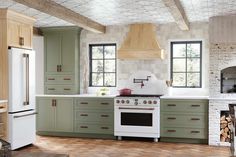 a kitchen with green cabinets and white appliances