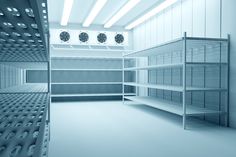 an empty room with shelves and clocks on the wall