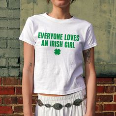 Everyone Loves An Irish Girl Baby Tee, Women's Fitted Tee, Y2K Slogan Tee, Trendy Top, Funny Shirt, Funny Sayings, 90s Style Tee DETAILS - 100% cotton (fiber content may vary for different colors) - tear-away label  SIZING Sizes vary by shirt style. Please check the size chart before making your purchase. PLEASE NOTE: Our Baby tee is sized for a youth, reminiscent of the '90s-era shrunken-down T-shirt. This style, popularized by the skater/raver culture of the time, is not to be confused with th 90s Green Tops With Letter Print, 90s Green Letter Print Tops, Y2k Green Tops With Screen Print, Y2k Style Green Tops With Screen Print, Green Cotton Band Merch Top, 90s Style Green Screen Print Top, Fitted Funny Print Band Merch Tops, Cute Green Top With Slogan, Y2k Slogan