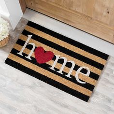 a door mat that says home with a heart on it