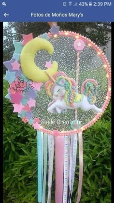 a pink and blue wind chime with a unicorn on it