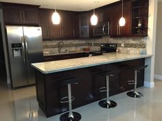 a kitchen with two bar stools in it