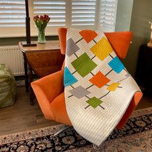 an orange chair sitting on top of a rug