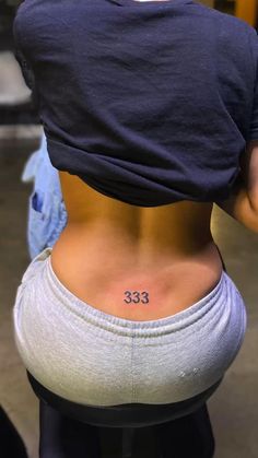 Angel Number Lower back  Tattoo. Tramp stamp. | Creative Tattoos by  Sydni Wingate Tattoo Ideas 333, Back Spine Tattoos, Tattoos Tramp Stamp, Angel Number Tattoos, Tattoo Tramp Stamp, Classy Tattoos For Women, 777 Tattoo, Lower Back Tattoo, Small Back Tattoos