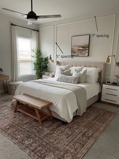 a bedroom with a bed, dressers and rug in it's center area