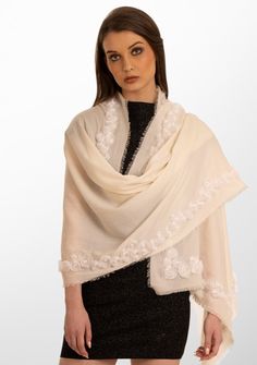 This luxurious classic ivory scarf seamlessly blends the richness of wool with the smoothness of silk offering both comfort andversatility. The hero of this scarf is a stunning border of three-dimensional roses, delicately hand-embroidered from a tonal ivory ribbon. This intricate handcrafted detailing captures the essence of classic sophistication andwill surely elevate the look of any ensemble, whether draped casually or adorned to enhance a more formal look. This is a unique masterpiece anda must-have for any wardrobe. Elegant Cream Embroidered Shawl, Elegant White Embroidered Scarf, Elegant Embroidered Cream Scarf, Elegant Embroidered Cream Scarves, Elegant Cream Embroidered Scarf, Elegant Cream Embroidered Scarves, Elegant Cream Dupatta With Floral Embroidery, Elegant White Shawl With Floral Embroidery, Rose Border