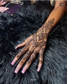 henna tattoo on the palm of a woman's hand