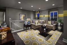 a living room filled with furniture and decor on top of a hard wood floored floor