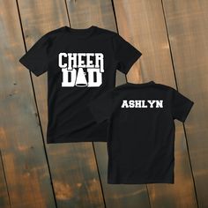 Custom Cheer Dad Shirt Make a statement of support with our custom cheer dad t-shirts! Available in various colors and sizes, these shirts are designed to be a perfect fit for any cheer dad. Personalize it with their name to make it truly one-of-a-kind. Wear it to cheer events, practices, or simply around town, and showcase your love and pride as a cheer dad! *Deets* *This custom shirt is handmade with professional vinyl. *Our shirts are unisex and are true to size! *In the photo's you will be able to see the custom options in regards to color that you may choose from. *We use 100% cotton shirts. The glitter material does not wash off and will last through multiple washes.  *If your shirt color is out of stock we will contact you as soon as possible to see if you would like to change shirt Cheer Dad Shirt Ideas, Cheer Dad Shirt, Cheer Dad Shirts, Varsity Cheer, Spirit Gear, Dad Tshirt, Dad Shirts, Cheer Dance, Love And Pride