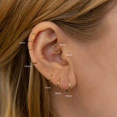 a woman's ear is shown with three different types of piercings