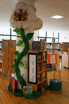 there is a book shelf with books on it in the middle of a library filled with children's books