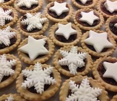 cookies decorated with white stars and snowflakes